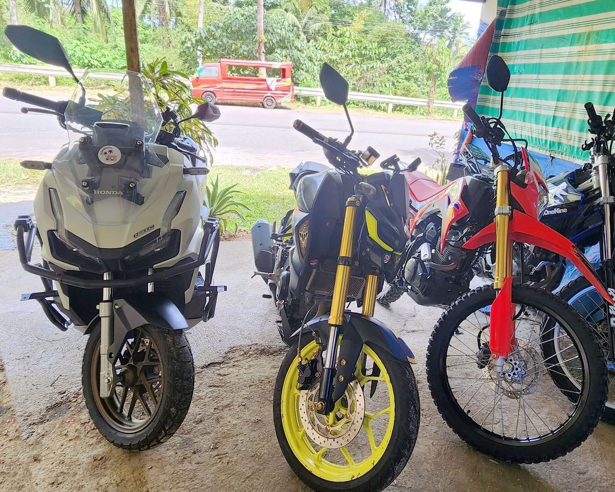Honda ADV 160, Yamaha MT-15, Honda CRF150L dirt bikes and a Yamaha WR155R parked side by side at the rental shop